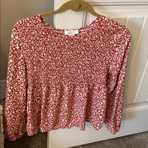 Red blouse with white flower embellishments